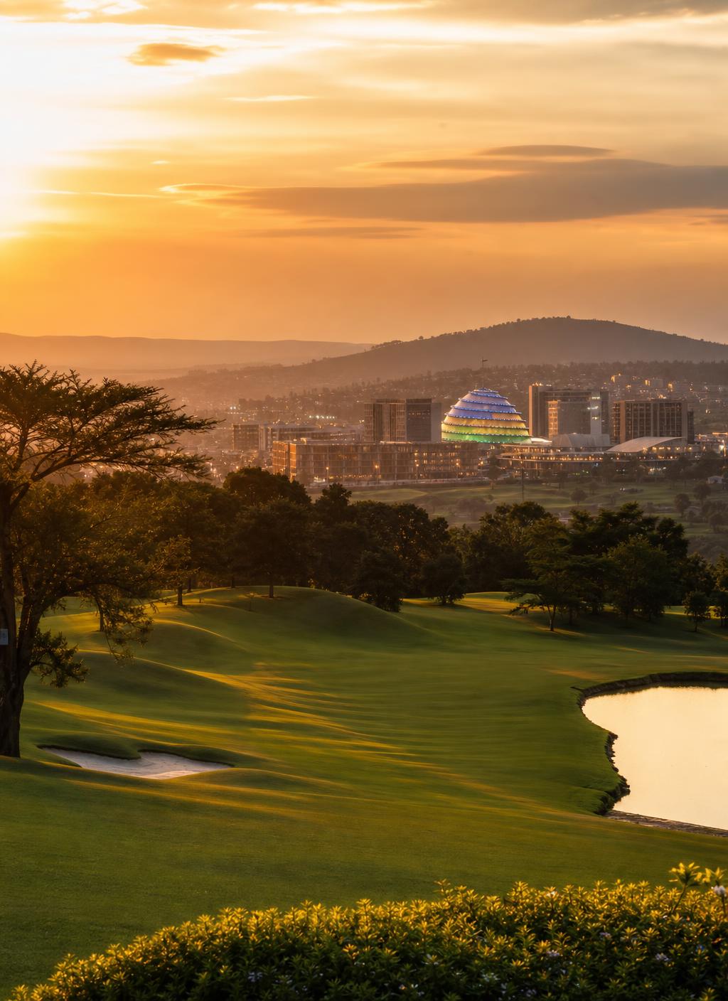Kigali at golden hour seen across the Nyarutarama golf course toward the Convention Centre